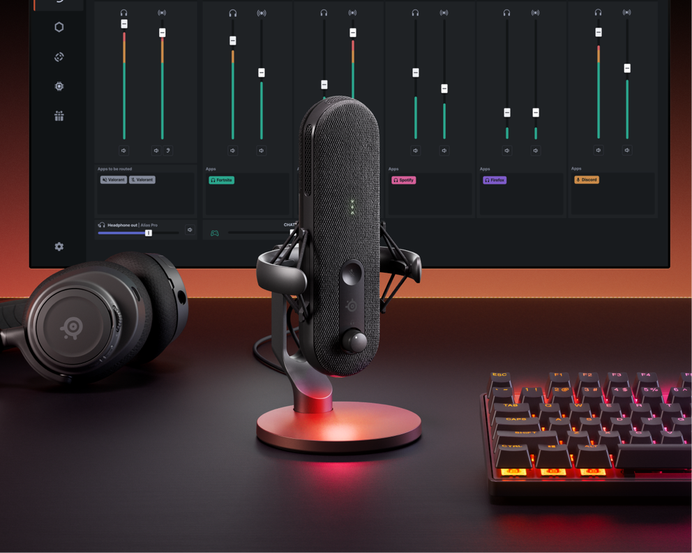  Angled view of the Alias gaming microphone. Behind the microphone is a screen showing Sonar for Streamers software user interface. The Alias microphone sits on a black desk, with an Arctis Nova headset next to it, and an Apex keyboard beside it. 